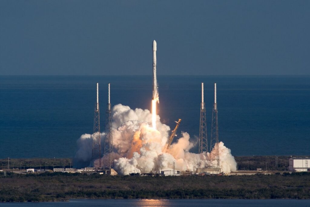 Falcon 9 launch from Cape Canaveral Space Force Station in Florida, rising above the ocean on the horizon.