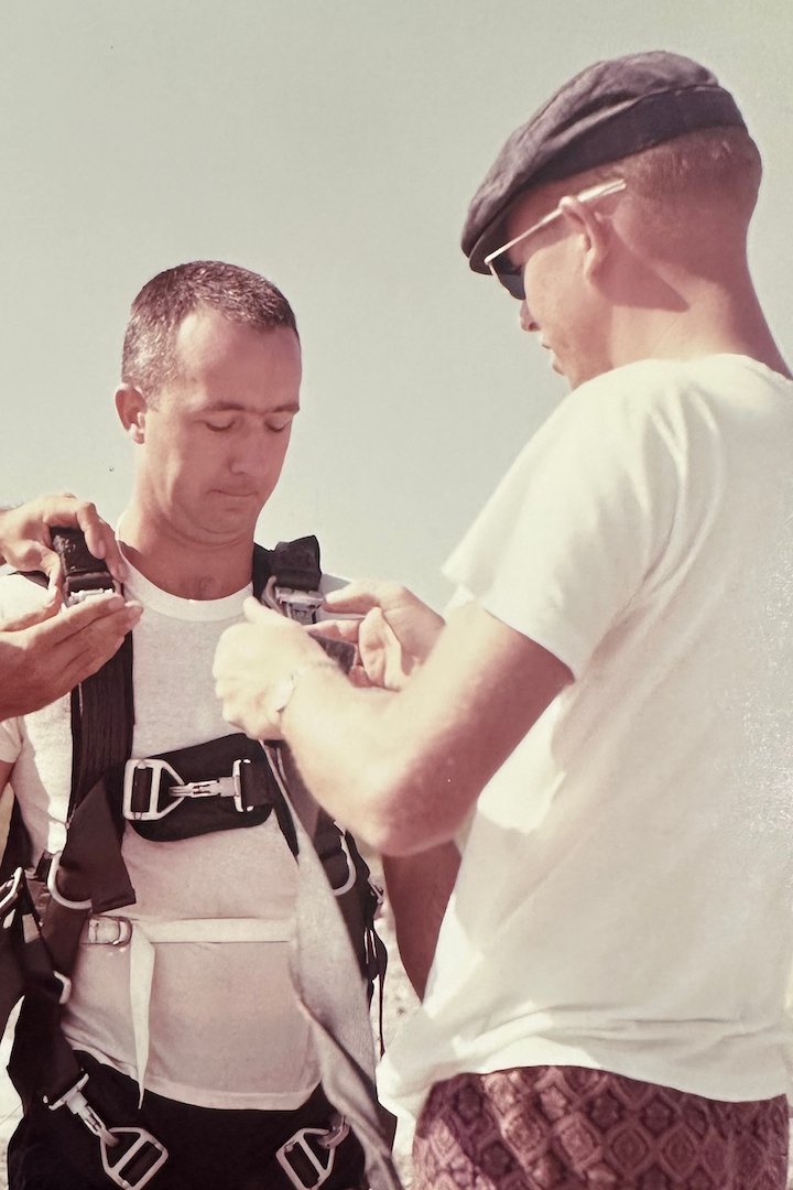 Coy Martin assisting and training Gemini astronaut James A. McDivitt on proper use of the parachute.