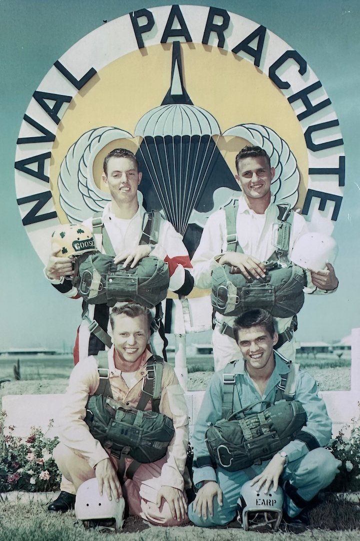 Coy Martin posing outside the Navy Parachute Facility in full jump gear and three fellow Chuting Stars.