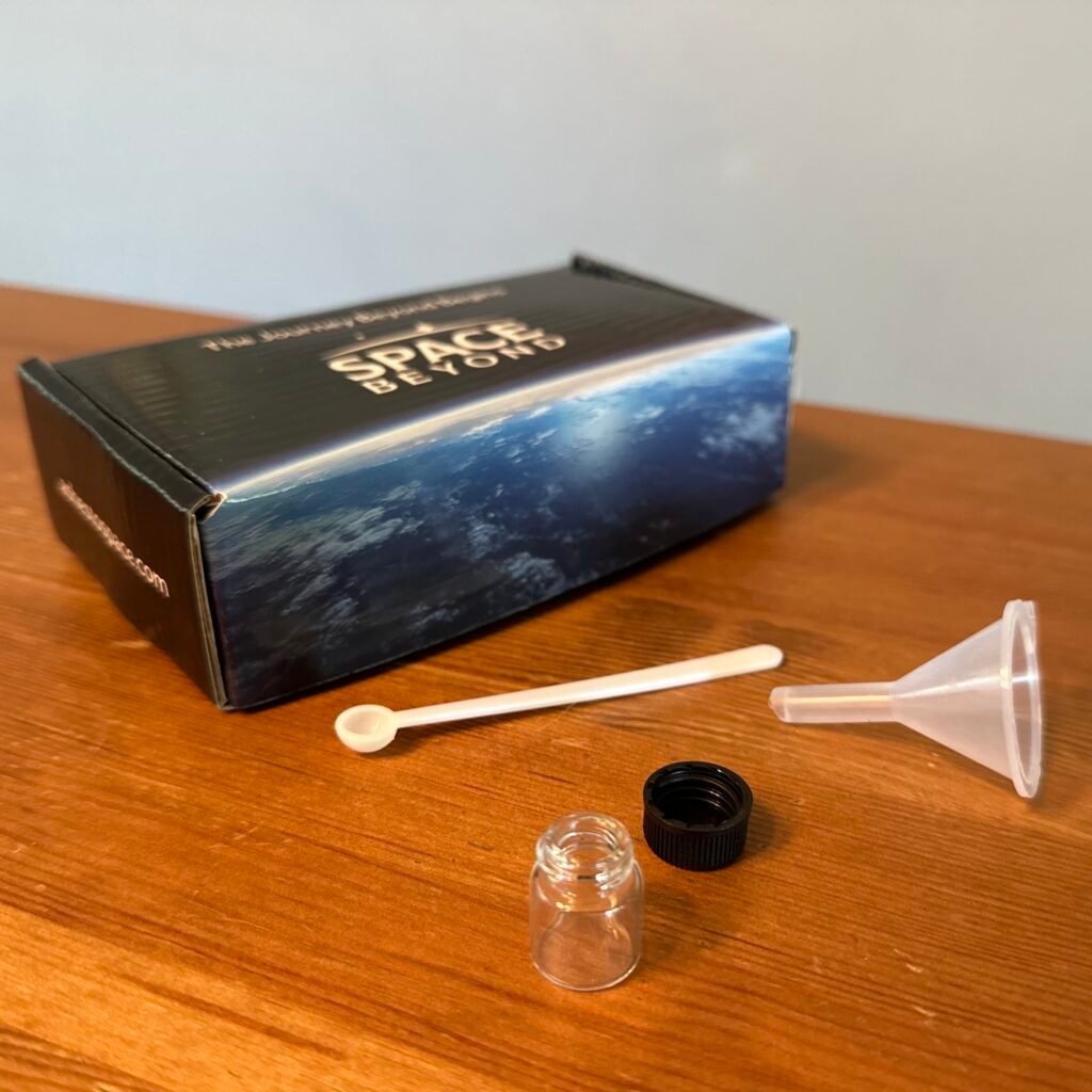 Mailer kit in custom mailer box, includes Celestial Tribute vial, spoon, and funnel.
