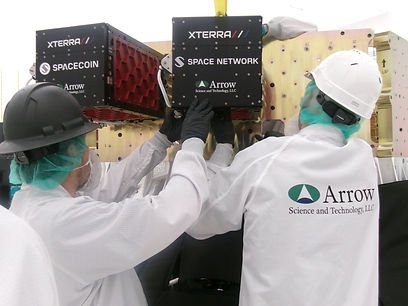 Arrow Science & Technology engineers installing the XTERRA c cubesat deployer onto a rocket.
