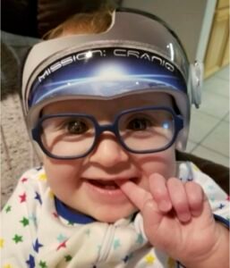 Kindyn Jinkins' baby boy Niko, in his Mission Cranio astronaut helmet and blue glasses, already on a mission.