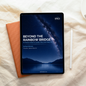 Beyond the Rainbow Bridge pet ashes guide cover displayed on a tablet lying on a linen surface next to an orange notebook and a stylus, showing a starry night sky over mountains and water